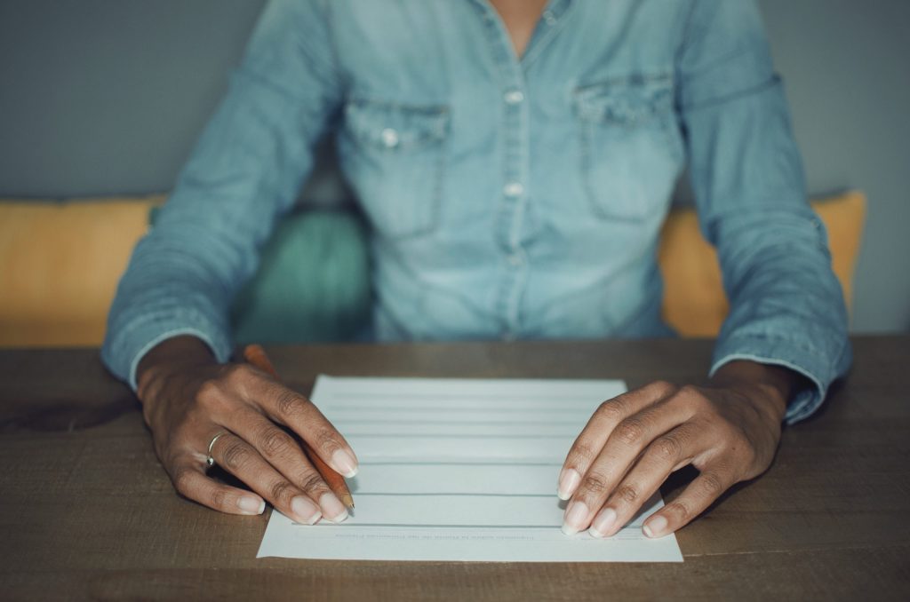 Woman at a desk with pen and paper