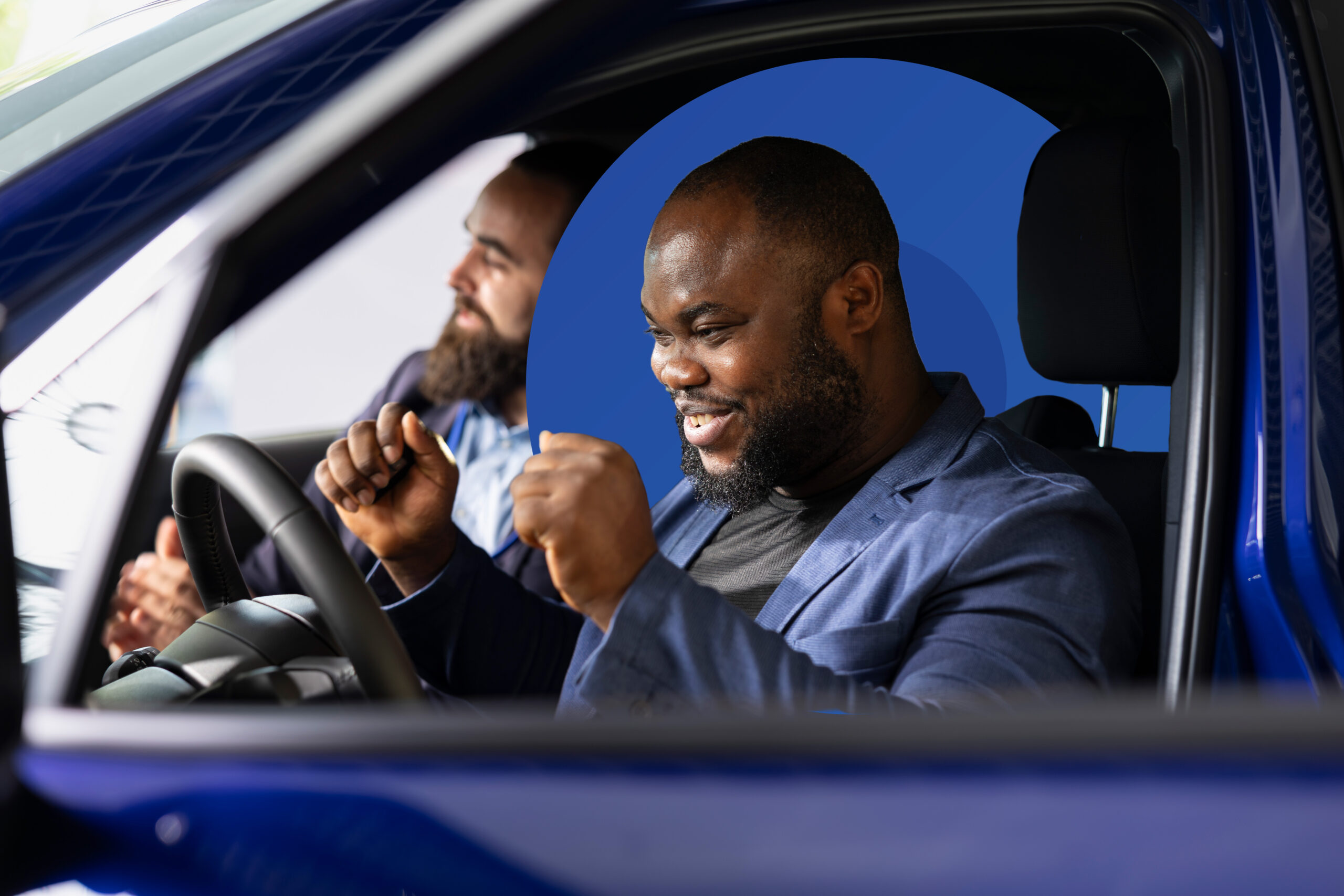 Excited man celebrating behind the steering wheel during a test drive