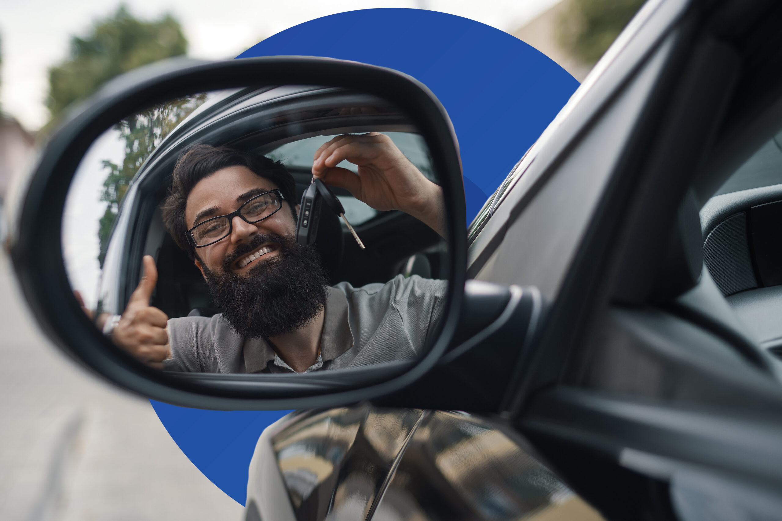 Driver showing car keys and giving a thumbs up seen in the side mirror